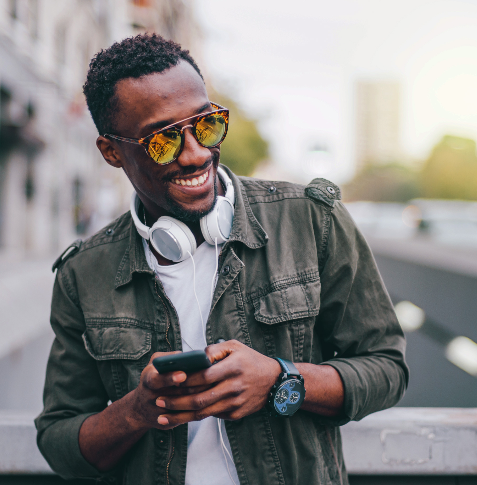 Man with sunglasses holding phone